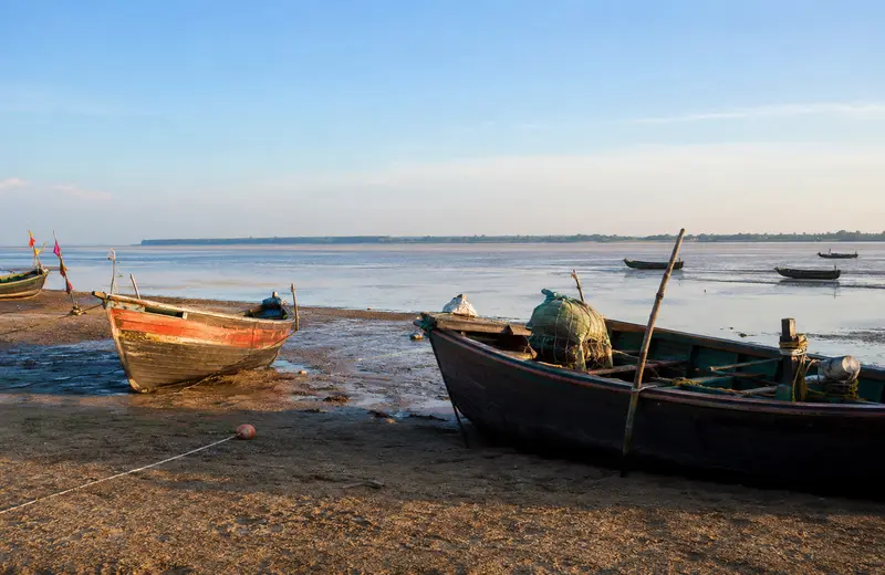 Fishing boats at Balaramgadi near Chandipur Beach Odisha, at the mouth of the Budhabalanga river during low tide.