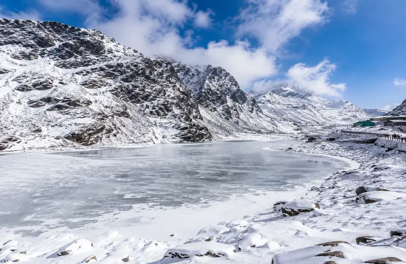 Frozen Tsomgo Lake surrounded by snow-covered mountains, East Sikkim