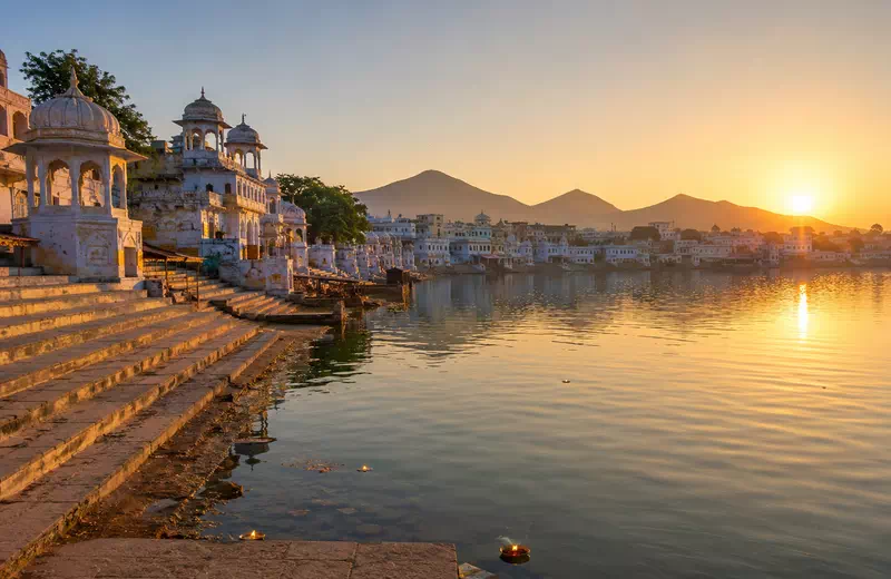 Pilgrims performing rituals at the sacred ghats of Pushkar Lake at sunrise, Rajasthan