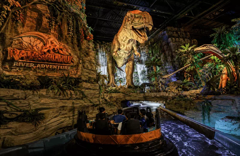 Rajasaurus River Adventure indoor water boat ride at Imagicaa theme park featuring animatronic dinosaurs in a prehistoric setting