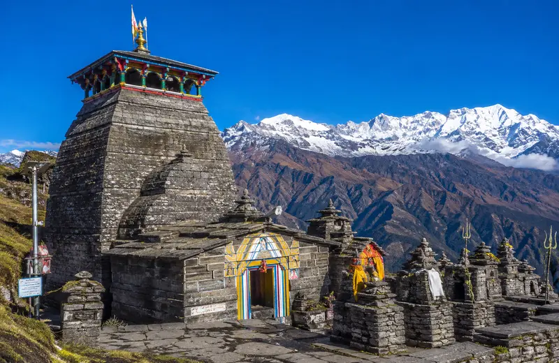 Tungnath temple above Chopta Uttarakhand, the world's highest Shiva temple, on the Chopta Chandrashila trek with Himalayan peaks behind.