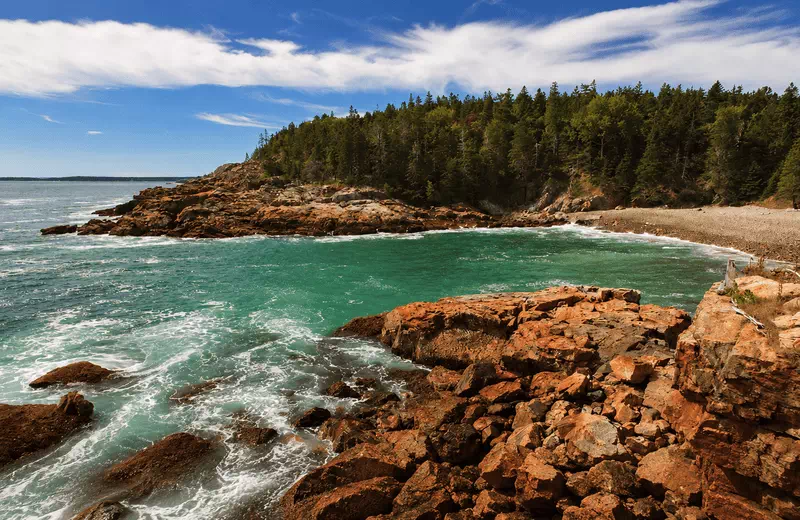 Coastal cliffs and clear turquoise water on the Maine coast, a top photo spot near Bar Harbor and Acadia