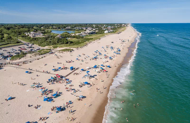 Coopers Beach in Southampton, New York, a wide, white-sand beach with calm waters.