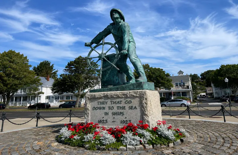 The Man at the Wheel Fishermen's Memorial statue overlooking Gloucester Harbor in America's oldest s