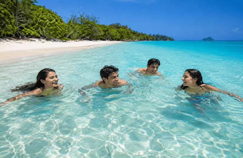 Crystal Clear Tropical Beach with Friends Swimming in Turquoise Water